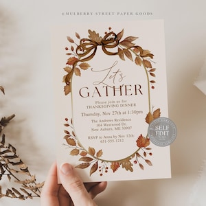 May include: Thanksgiving dinner invitation with a fall theme. The card features a decorative oval frame with autumn leaves and a bow. The text reads "Let's Gather" and includes event details.
