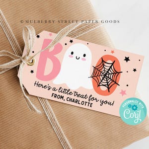 May include: A pink and orange Halloween gift tag with a ghost and spider web illustration. The tag says "Here's a little treat for you! From, Charlotte".
