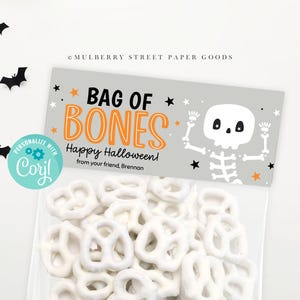 May include: A gray and orange Halloween treat bag with a skeleton graphic and the text "Bag of Bones Happy Halloween! from your friend, Brennan".