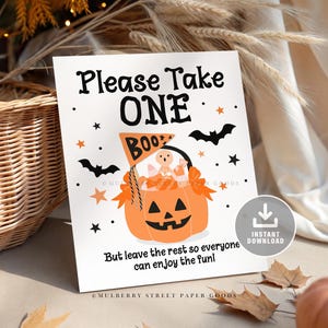 May include: A white Halloween-themed sign with the text "Please Take ONE BOO". The sign features an orange jack-o'-lantern with candy and a ghost. Black bats and stars decorate the sign. The text "But leave the rest so everyone can enjoy the fun!" is also included.