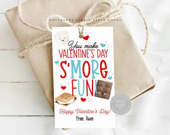 May include: A printable Valentine's Day gift tag with a s'more theme. The tag features a cartoon s'more with a marshmallow, chocolate bar, and graham cracker. The text reads "You make Valentine's Day s'more fun! Happy Valentine's Day! From. Owen".