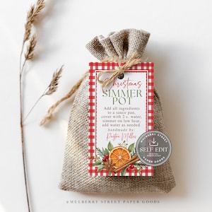 May include: A rectangular tag with a red and white gingham border tied to a tan burlap drawstring bag. The tag features the text Christmas Simmer Pot, instructions, and an illustration of orange slices, cinnamon sticks, and greenery.