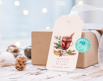 May include: A rectangular white gift tag with a watercolor illustration of a glass of mulled wine, cinnamon sticks, orange slices, and pine needles. The text reads "making spirits bright" and "The Schultz Family". A white ribbon is attached.