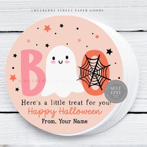 May include: Round stickers with a light pink background featuring a cartoon ghost, the word "BOO", and a spiderweb. The stickers also include the text "Here's a little treat for you! Happy Halloween From, Your Name".