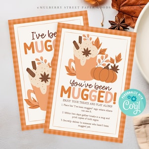 May include: Two printable signs with a fall theme. The signs say "I've been mugged" and "You've been mugged!" with a mug of hot chocolate and a pumpkin. The signs have instructions for a fun fall game.