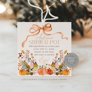 May include: A square tag with a watercolor design featuring pumpkins, flowers, and the text "Autumn Simmer Pot." The tag includes instructions for making a simmer pot and is tied with a ribbon. The tag is a fall-themed item.