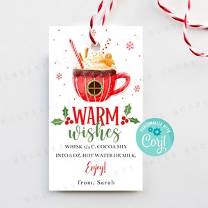 May include: A red and white Christmas gift tag featuring a festive illustration of a mug of hot chocolate topped with whipped cream and a gingerbread man. The tag includes the text "Warm wishes" and instructions for making the hot chocolate: "Whisk 1/4 c. cocoa mix into 8 fl oz. hot water or milk. Enjoy!" The tag is personalised with the name "Coryl" and the sender's name, "Sarah".