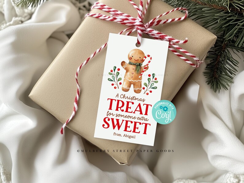 May include: A white gift tag with a gingerbread man illustration and the text "A Christmas Treat for someone extra Sweet from Abigail".