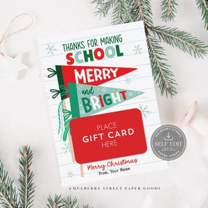May include: A Christmas gift card holder with the message "Thanks for Making School Merry and Bright." The design features red and green pennant flags, snowflakes, and a red rectangle for a gift card. The card is decorated with pine branches.