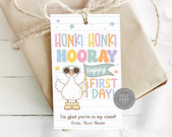 May include: A gift tag with a cartoon goose wearing sunglasses and holding a flag that says "Happy First Day!". The tag has the words "Honk! Honk! Hooray!" in colorful letters. The text "I'm glad you're in my class!" is also included.