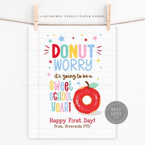 May include: A colorful school-themed print with the words "DONUT WORRY" and "Sweet SCHOOL YEAR!" A red donut with a green stem is featured. The print is hanging from a clothesline.