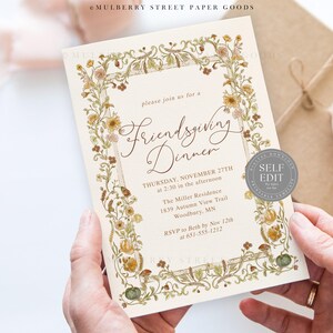 May include: An invitation for a Friendsgiving Dinner, featuring floral and botanical illustrations. The text reads "Friendsgiving Dinner" and includes the date, time, and location. The invitation is held in hands.