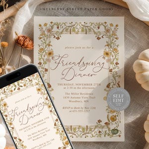 May include: An invitation for a Friendsgiving Dinner, featuring floral border designs and elegant script. The invitation is displayed on a smartphone and a printed card, with pumpkins and dried flowers in the background.