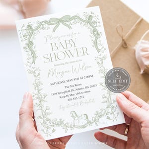 May include: A baby shower invitation with a floral design in light green. The invitation includes the text "BABY SHOWER" and event details. The invitation is held in hands, with a gift box and ribbon in the background.