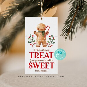 May include: A Christmas gift tag featuring a gingerbread person illustration with a red candy cane. The tag reads "A Christmas Treat for someone extra SWEET from. Abigail" and has a customizable area with the text "PERSONALIZE WITH Cory!"