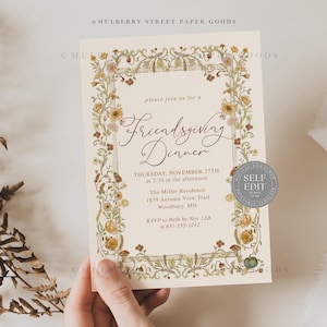 May include: An invitation for a Friendsgiving Dinner, featuring floral border and elegant script. The text includes the date, time, and location: Thursday, November 27th at 2:30 PM at The Miller Residence in Woodbury, MN. A self-edit seal is on the right.