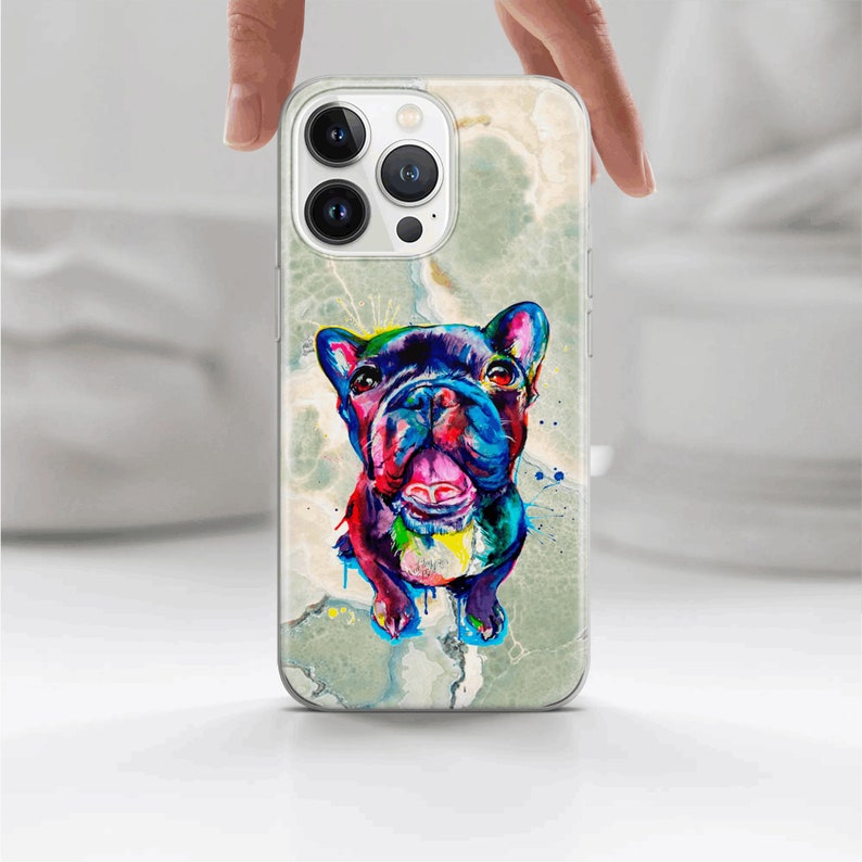 May include: A clear phone case with a colorful abstract painting of a French Bulldog on a marble background.