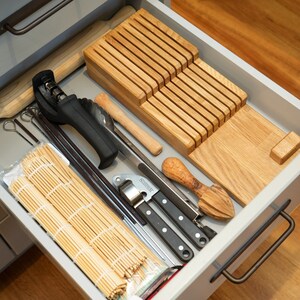 DIY Knife Block made from wood scrapes that neatly organises your knifes in a drawer. This block is made from offcuts from our oak worktop. The block holds up to 9 knifes, but can be cut narrower to use up less space if desired.