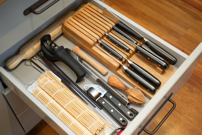 DIY Knife Block made from wood scrapes that neatly organises your knifes in a drawer. This block is made from offcuts from our oak worktop. The block holds up to 9 knifes, but can be cut narrower to use up less space if desired.