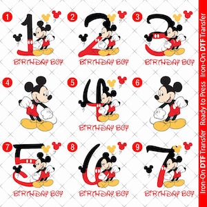 May include: Nine iron-on transfers featuring Mickey Mouse in a red and black outfit with yellow shoes. Each transfer includes a number from 1 to 9 and the text "Birthday Boy".