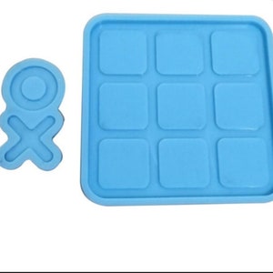 May include: A blue silicone mold with nine square cavities and a separate mold of a circle with a cross inside.
