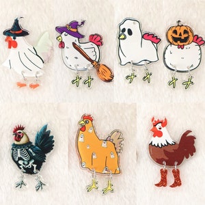 May include: Set of ten Halloween-themed chicken charms. The charms feature a variety of designs, including a witch, a ghost, a pumpkin, a skeleton, and a rooster. The charms are made of clear acrylic and have a shiny finish.
