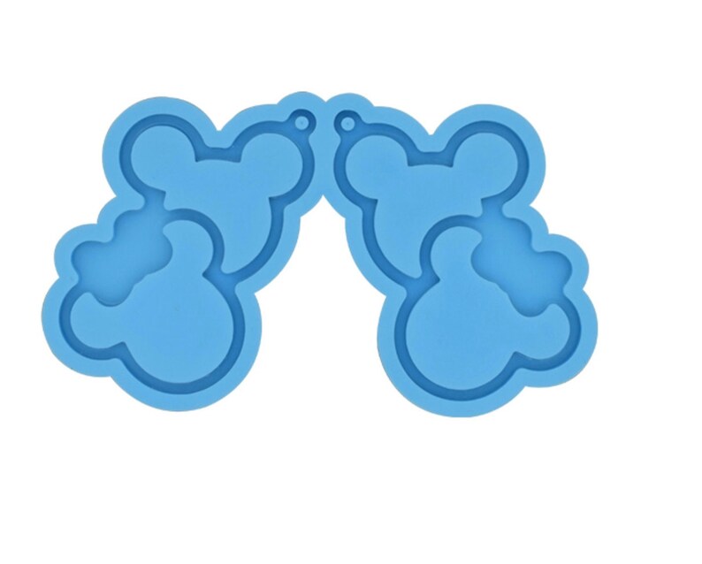 May include: A blue silicone mold for making resin earrings. The mold is shaped like two pairs of Mickey Mouse ears.