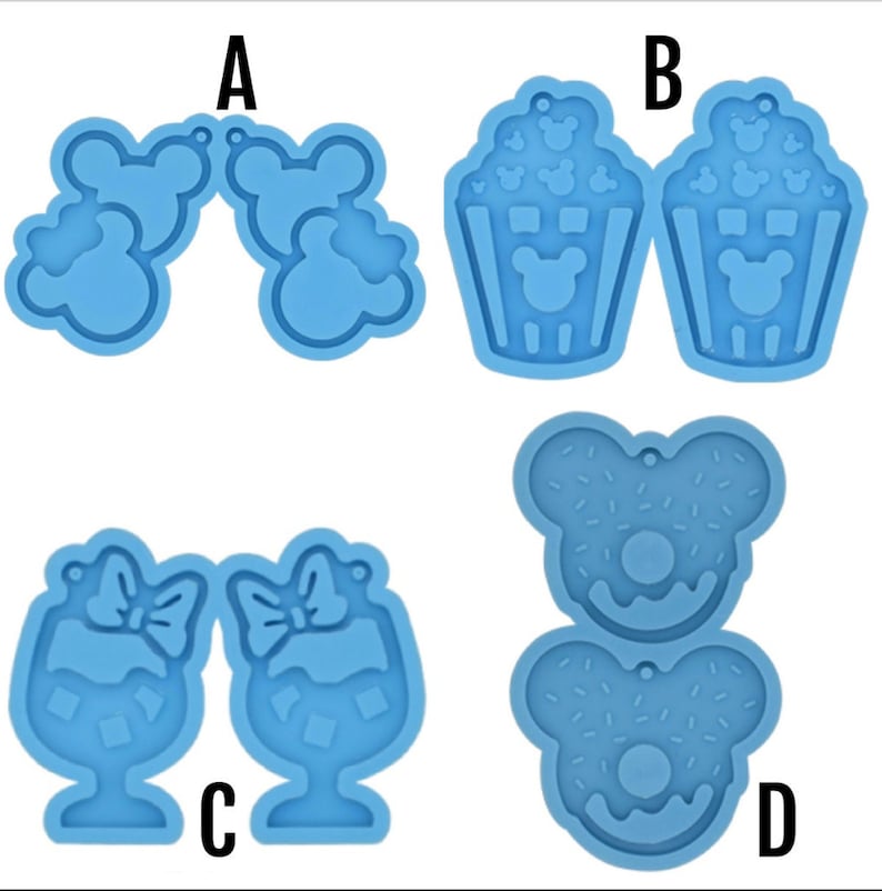 May include: Four silicone molds for making resin earrings. The molds are blue and feature different designs: Mickey Mouse ears, popcorn buckets, wine glasses, and donuts. The molds are labeled A, B, C, and D.