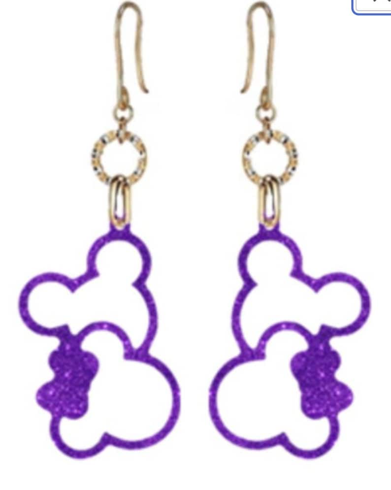 May include: Purple glitter Mickey Mouse silhouette dangle earrings with gold hoops and hooks.