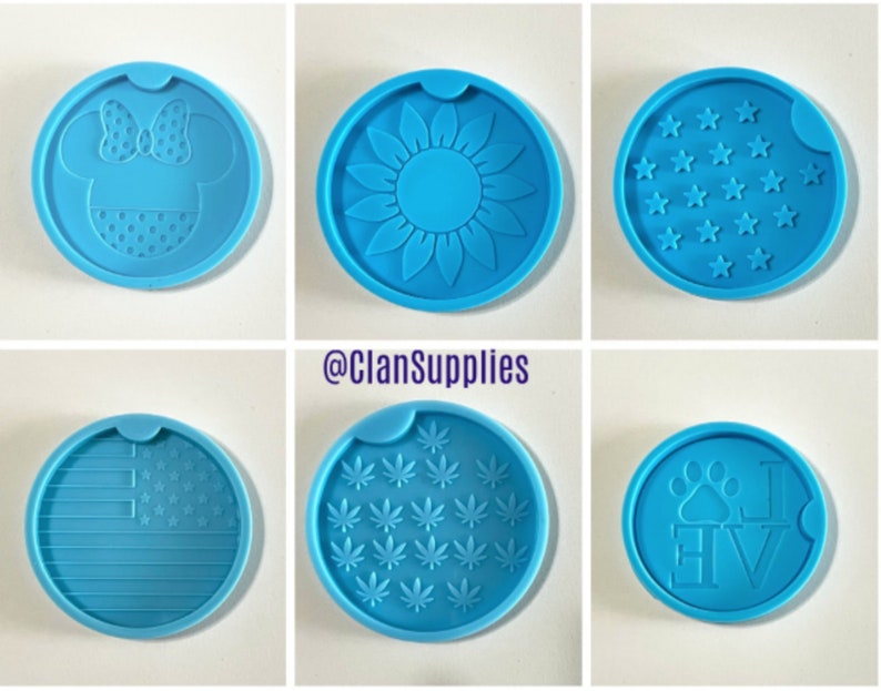 May include: Six different silicone molds for making coasters. The molds are round and blue. The designs include a sunflower, a paw print with the word "love", a marijuana leaf, a Mickey Mouse head, a US flag, and a field of stars.