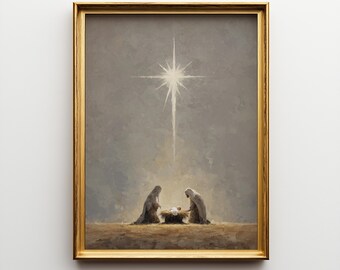 May include: A framed print depicting a religious scene. The artwork features two figures kneeling near a manger, illuminated by a bright star in the sky. The frame is gold-colored, and the overall color palette is muted.