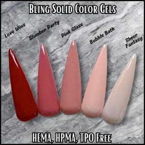 May include: Five gel nail polish samples in shades of red, pink, and nude. The colors are labeled "Love Wins", "Slumber Party", "Pink Glaze", "Bubble Bath", and "Sheer Fantasy". The text "BLING SOLID COLOR GELS" and "HEMA, HPMA, TPO FREE" are also visible.