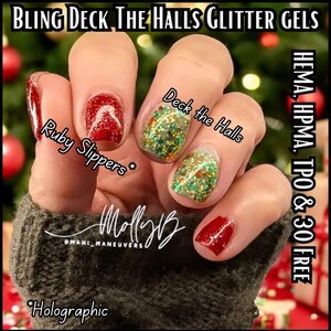 May include: Close-up of a hand with four fingernails painted with red and green glitter nail polish. The nails are labeled "Ruby Slippers*" and "Deck the Halls". The text "*Holographic" is at the bottom of the image. The text "HEMA, HPMA, TPO & 30 FREE" is on the right side of the image.