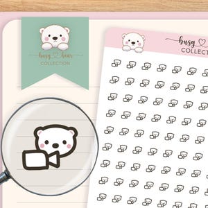 May include: A sheet of stickers featuring a white bear with a speech bubble. The stickers are black and white and are arranged in a grid pattern. The sheet is labeled "busy bear collection".