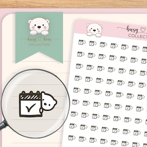 May include: A collection of planner stickers featuring a calendar icon with a checkmark and a cute bear illustration. The stickers are white on a clear background. The brand name "busy bear COLLECTION" is also visible.