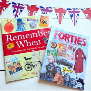 May include: Two books with colorful covers, one titled "Remember When" and the other "The Forties." The "Remember When" book has a red cover with various nostalgic images. The "The Forties" book has a blue cover with images of the 1940s. Union Jack bunting is in the background.