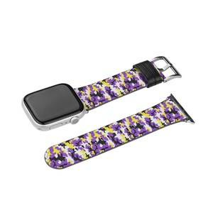 May include: A purple, yellow and white camouflage patterned Apple Watch band with a black leather strap and silver buckle.