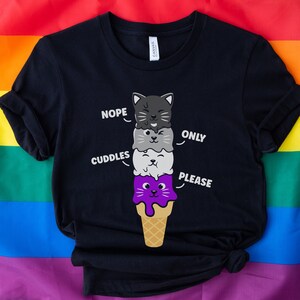 May include: Black t-shirt with a graphic of a stack of ice cream cones with cat faces. The text "Nope", "Cuddles", "Only", and "Please" are written around the ice cream cones.
