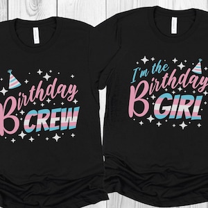 May include: Two black t-shirts with birthday designs. One says "Birthday Crew" in pink and blue, with a party hat and stars. The other says "I'm the Birthday GIRL" in pink and blue, with a party hat and stars.