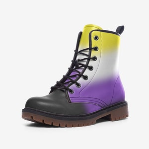 May include: Black leather combat boots with a yellow, white and purple ombre design. The boots have a lace-up closure and a chunky sole.