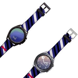 May include: Two black smartwatches with blue, white, and black striped bands. The watch faces show the time and date. The bands have a red and white bone design.