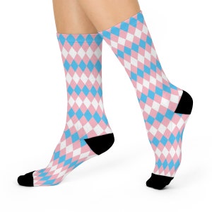May include: A pair of socks with a pink and blue diamond pattern. The socks are crew length and have a black heel and toe.