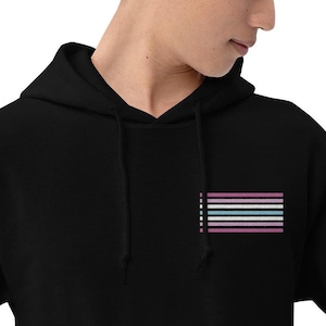 May include: Black hooded sweatshirt with a transgender pride flag printed on the front.