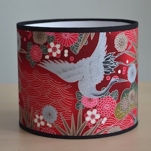 Round lampshade in red, fuchsia pink, silver and green Japanese fabric with a crane bird and flower motif; suitable for table lamps, floor lamps, and ceiling lights. image 1