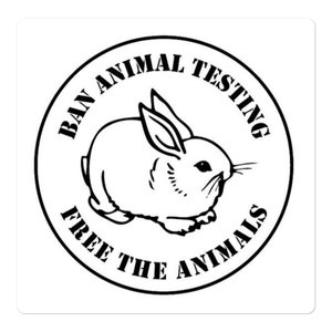 May include: Black and white sticker with a circular design. The circle features the text "Ban Animal Testing Free The Animals" around the edge. Inside the circle is a drawing of a rabbit.