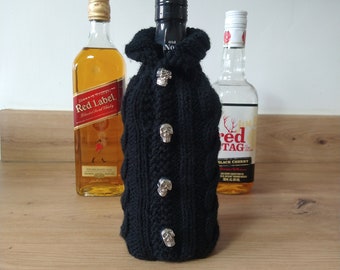 Handmade knitted cable whisky bottle cover cosy