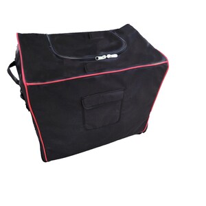 May include: Black duffel bag with a red trim and a zipped top. The bag has a small pocket on the front.