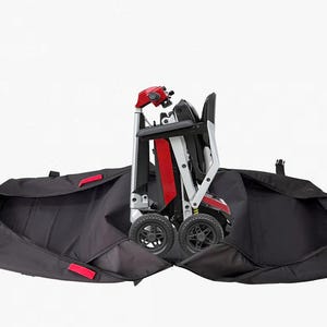 May include: Folded red, black, and silver mobility scooter with black wheels, inside a black carrying case with red accents. The scooter has a black seat and a red control panel. The carrying case is open, displaying the scooter.