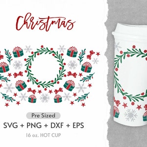 May include: A white 16 ounce hot cup with a Christmas design. The design features a green wreath with red berries, red stars, snowflakes, and red bows. The text "Christmas" is written in red at the top of the image.