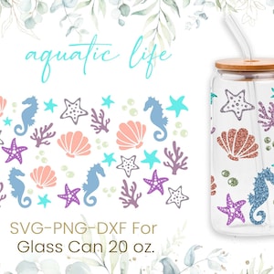 May include: A 20 ounce glass can with a bamboo lid and a straw. The can is decorated with a repeating pattern of seahorses, starfish, seashells, and coral in shades of blue, pink, purple, and green. The text "aquatic life" is written in blue at the top of the image.